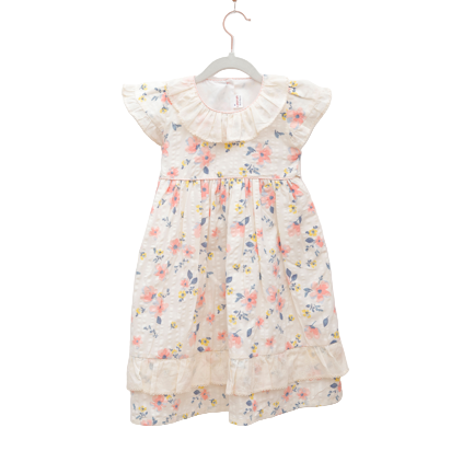 Floral dress on a hanger against a white wall