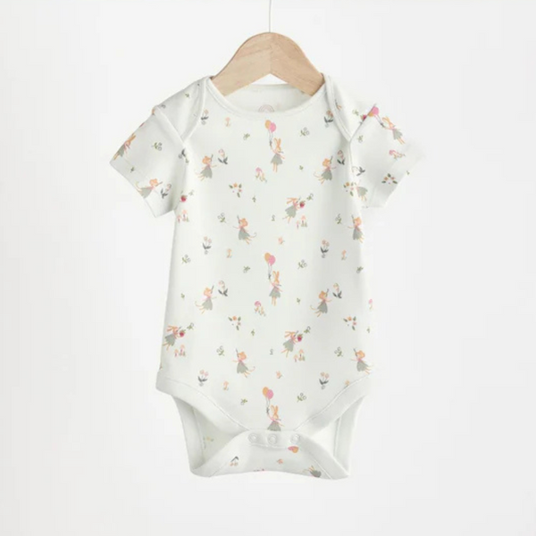A short sleeve bodysuit for babies, hanging on a wooden hanger, with a pattern of green bunny and fairy motifs.