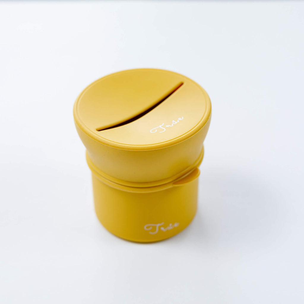 True silicone snack lid with cup in yellow color, BPA Free. The lid has a sliced opening in the middle.