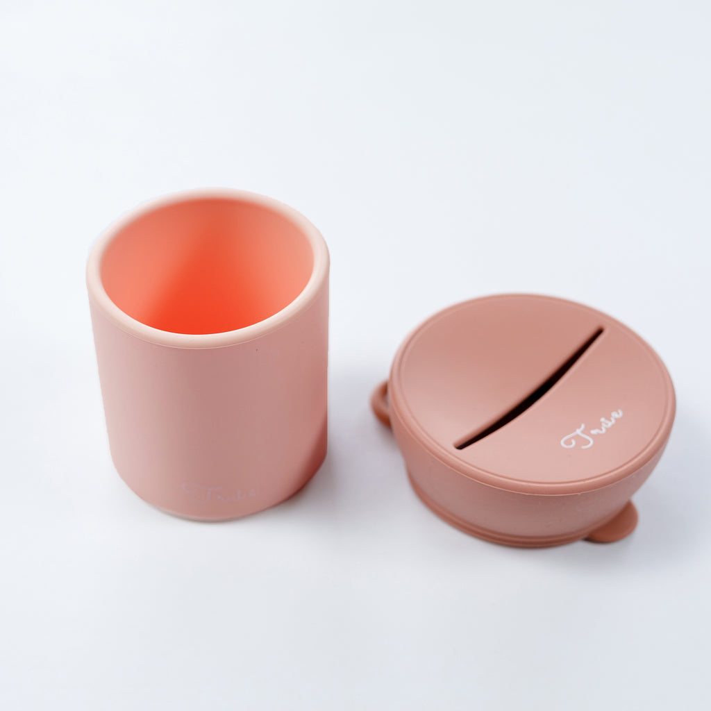 True silicone snack lid with cup in pastel purple color, BPA Free. The lid has a sliced opening in the middle.