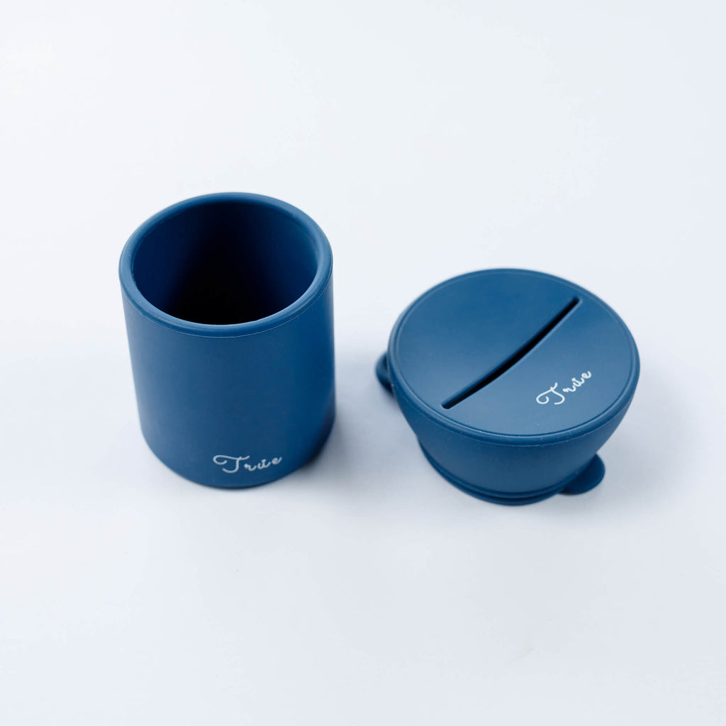 True silicone snack lid with cup in blue color, BPA Free. The lid has a sliced opening in the middle.