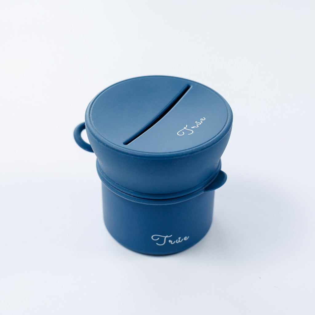 True silicone snack lid with cup in blue color, BPA Free. The lid has a sliced opening in the middle.