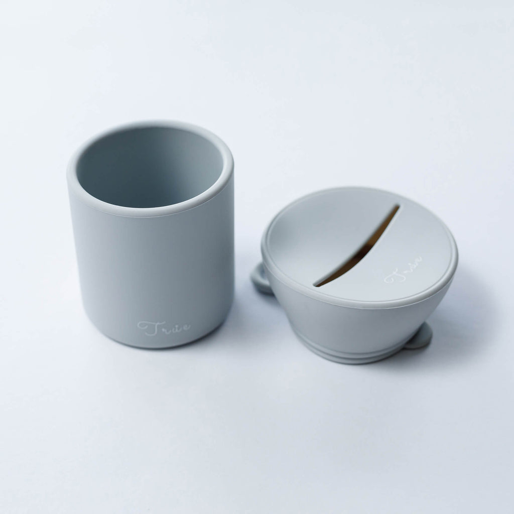True silicone snack lid with cup in light grey color, BPA Free. The lid has a sliced opening in the middle.