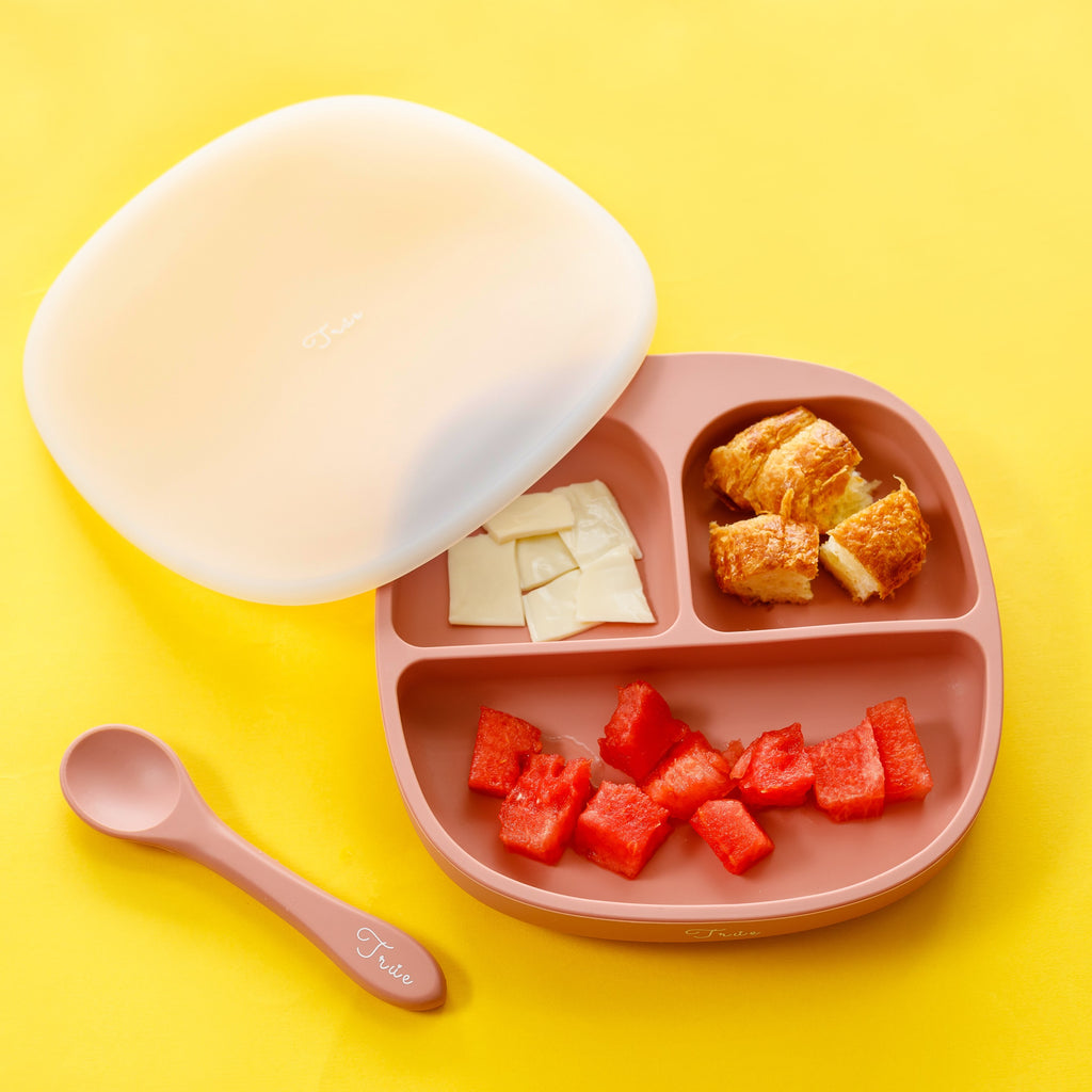A silicone suction divided plate for kids. Each plate has three compartments of varying sizes to separate food portions.