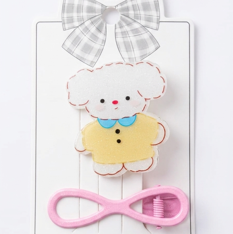 Cartoon sheep hair clip with pink bow and checkered ribbon on a white background