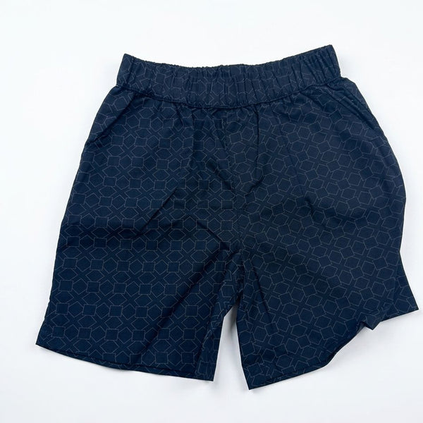 Navy blue shorts with a geometric pattern on a white background