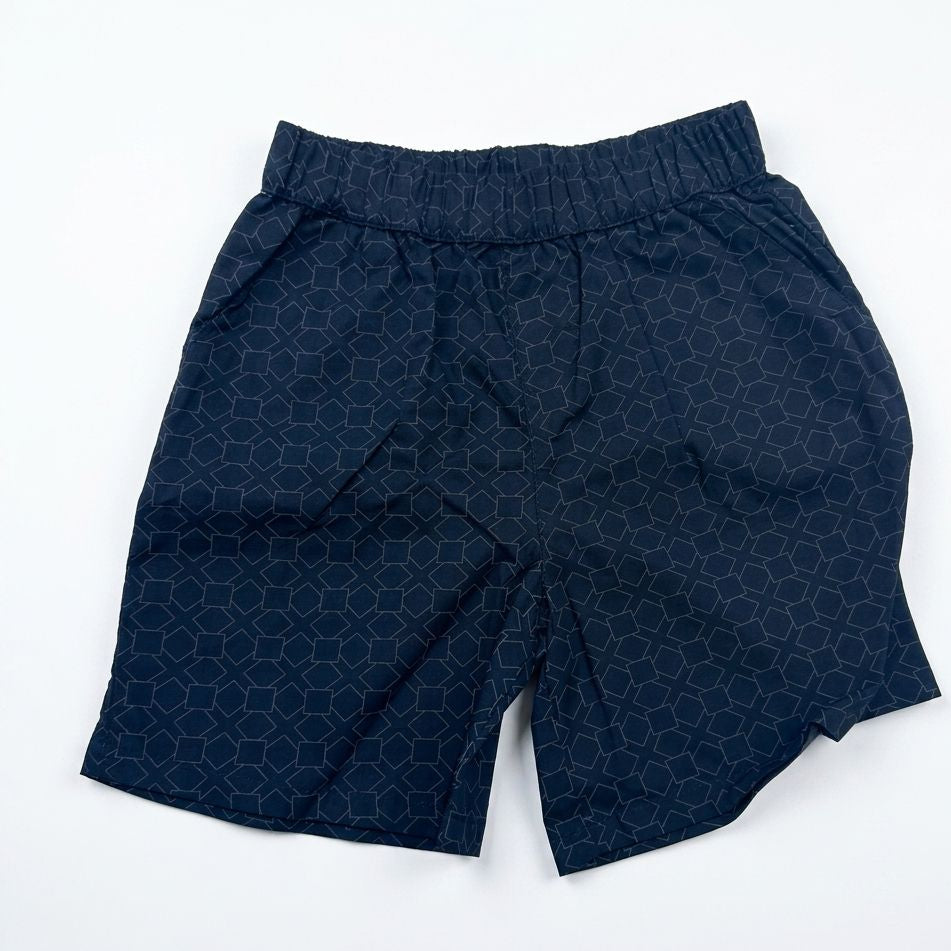 Navy blue shorts with a geometric pattern on a white background