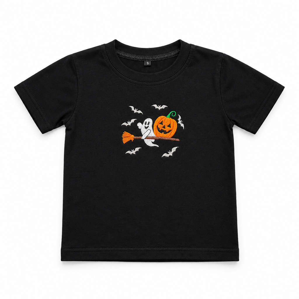 A black short-sleeve kids' t-shirt featuring a Halloween graphic of a jack-o'-lantern, a ghost on a broomstick, and flying bats, displayed on a clean white background.