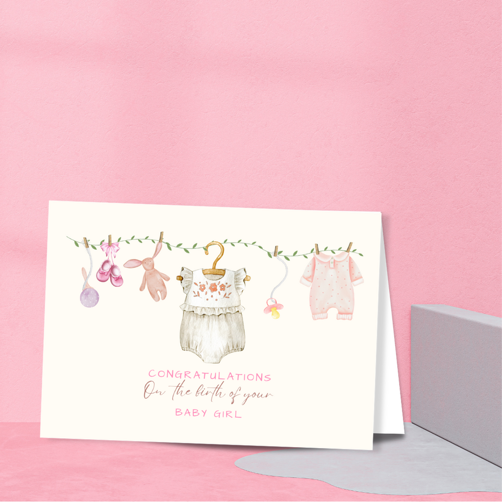 Greeting card with baby-themed illustrations on a pink background