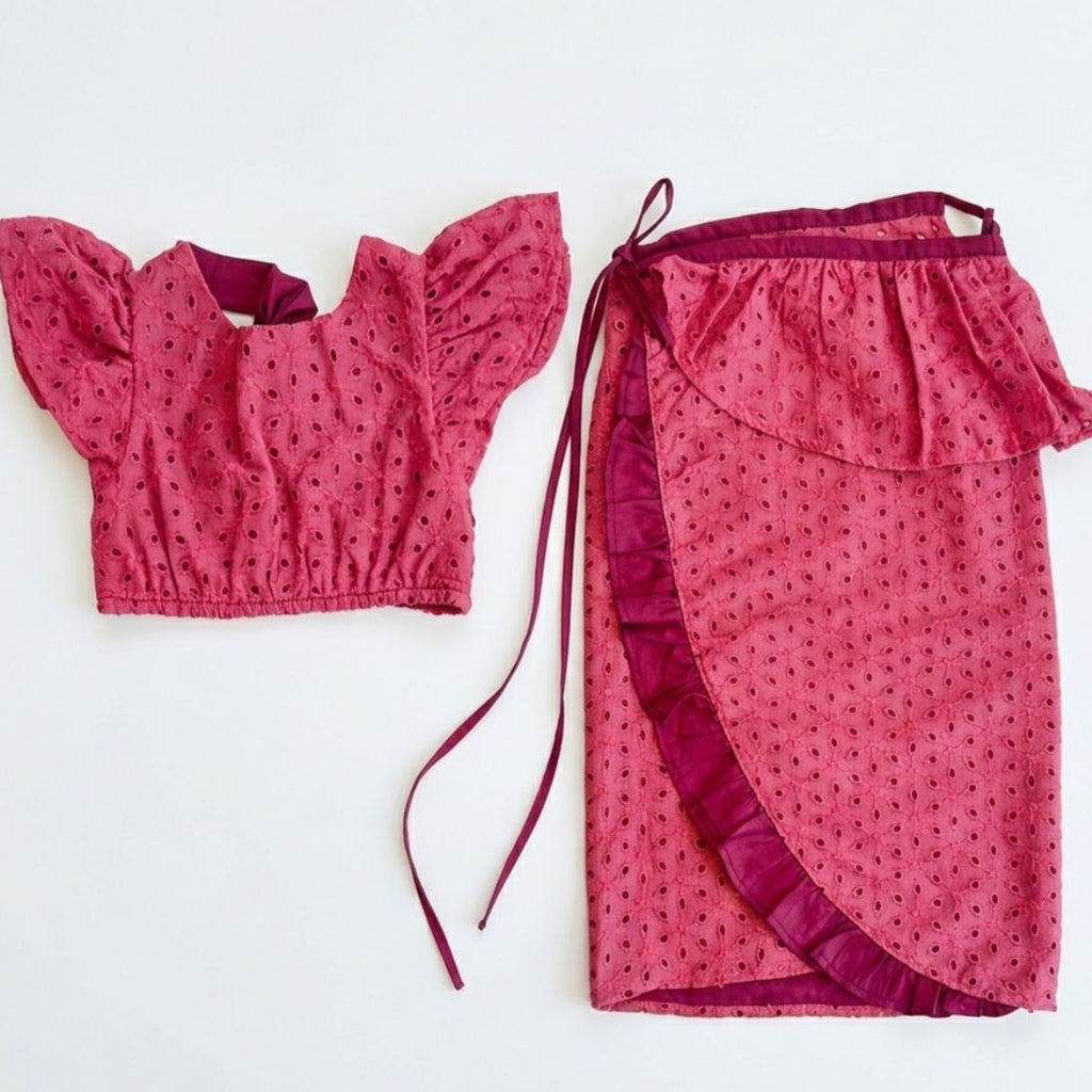 Pink patterned top and skirt set on a white background