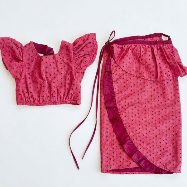 Pink patterned top and skirt set on a white background