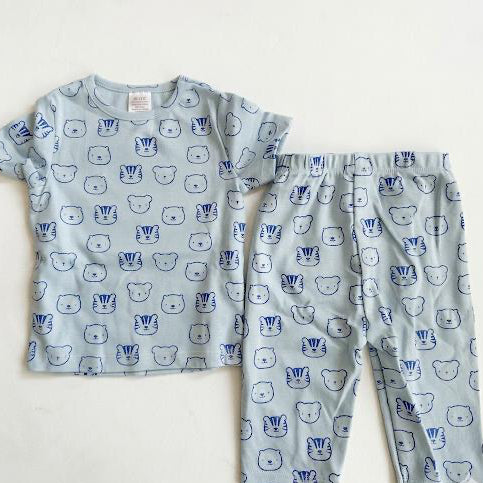 Children's pajama set with bear pattern on a light blue background