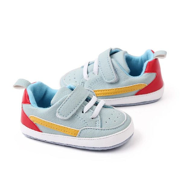 Colorful baby sneakers with red, blue, and yellow accents on a white background