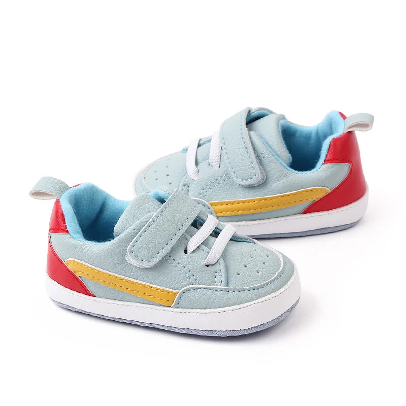 Colorful baby sneakers with red, blue, and yellow accents on a white background