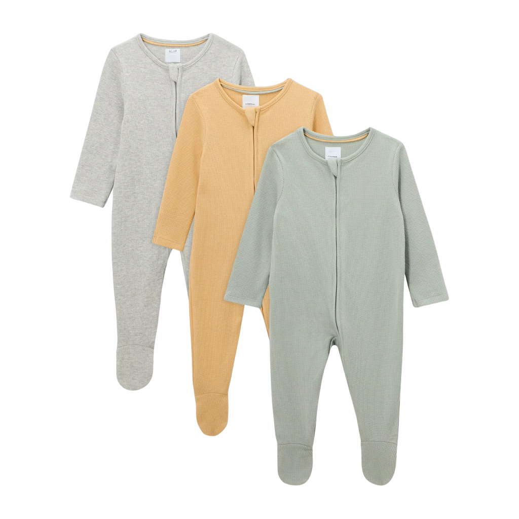 Three baby onesies in gray, mustard yellow, and green on a white background