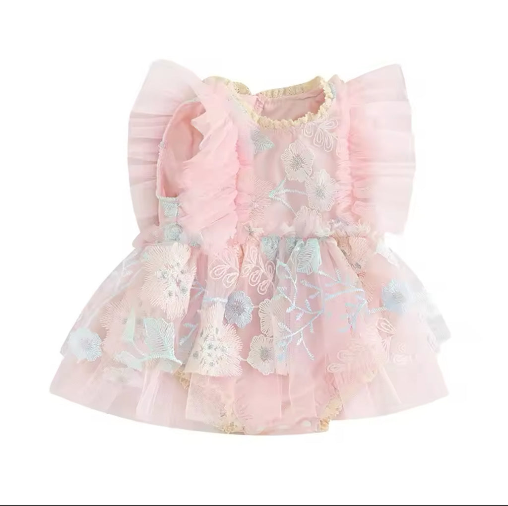 A pink baby dress with floral embroidery and ruffled layers.