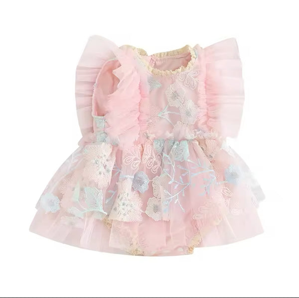 A pink baby dress with floral embroidery and ruffled layers.