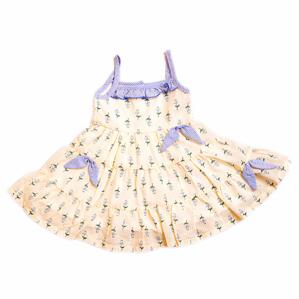 Yellow dress with blue accents on a white background