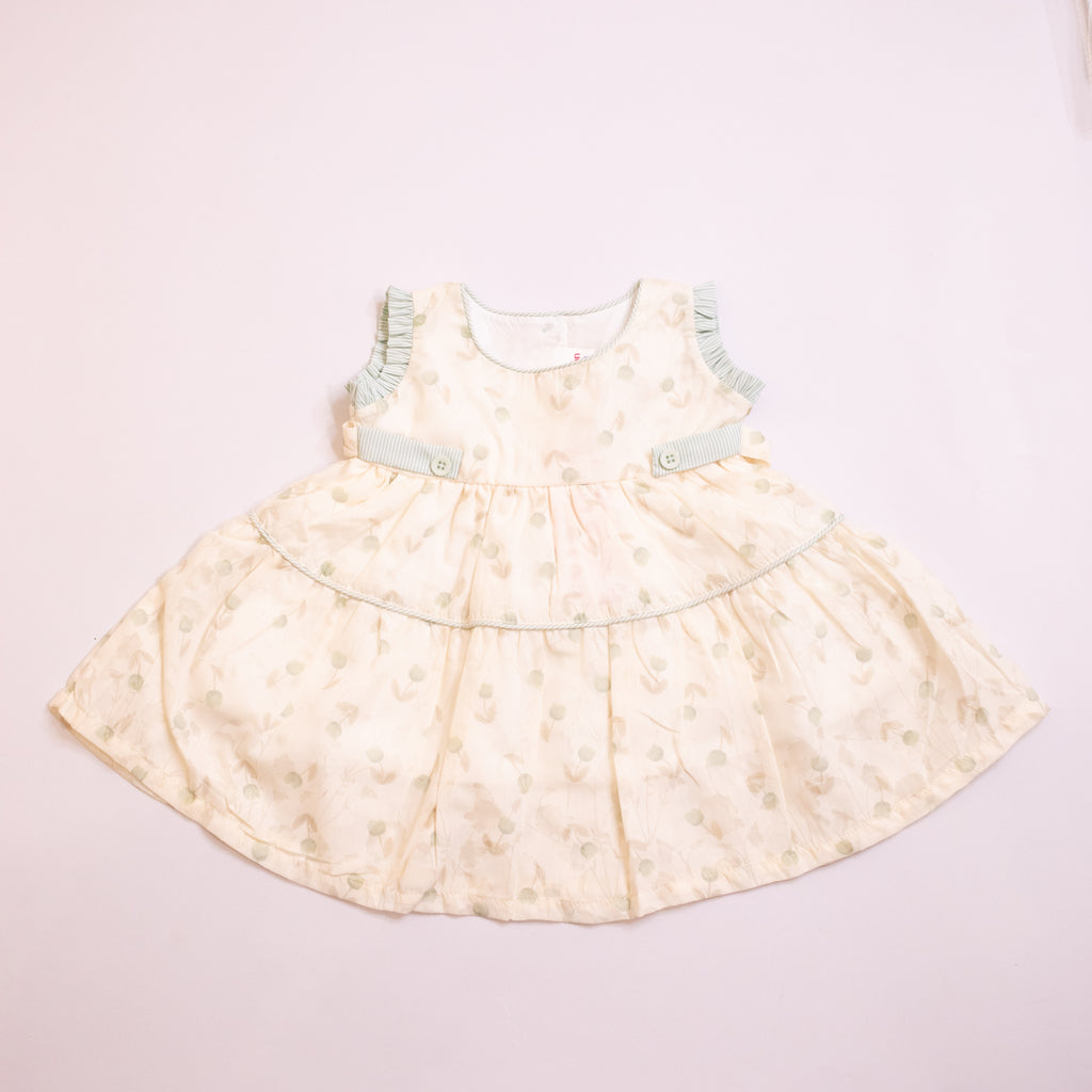 Light-colored dress with floral pattern on a light pink background