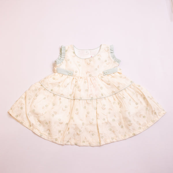 Light-colored dress with floral pattern on a light pink background