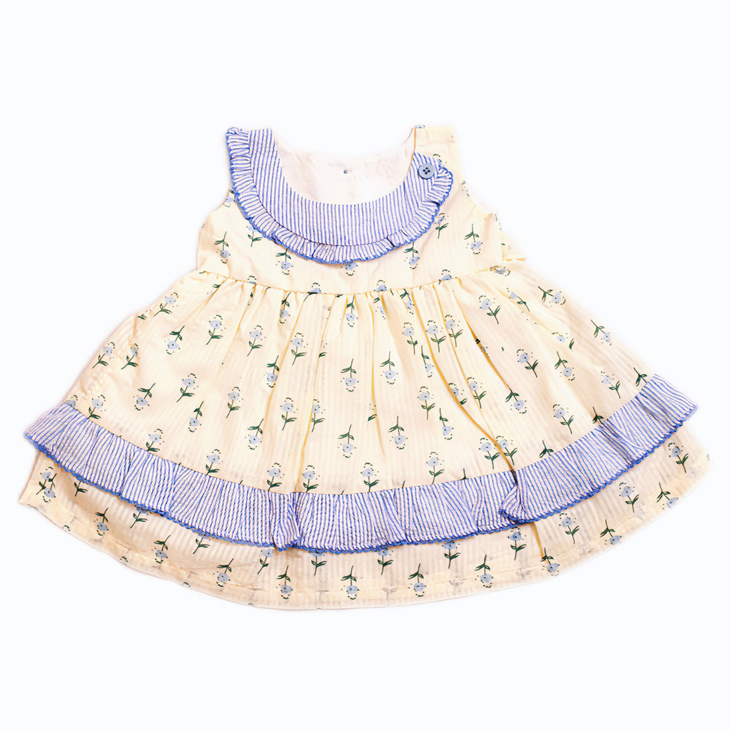 Children's dress with floral pattern and blue trim on a white background