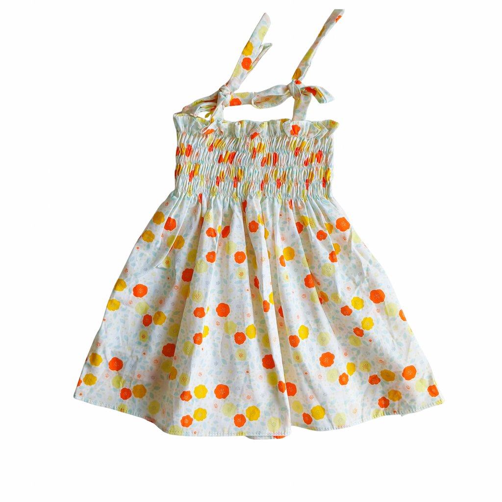 Baby girl floral smocked dress with orange and yellow details on a white background