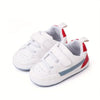 White children's sneakers with red and gray accents on a white background