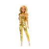 A blonde fashion doll wearing a shiny metallic gold jumpsuit with a matching gold choker, standing against a plain white background.