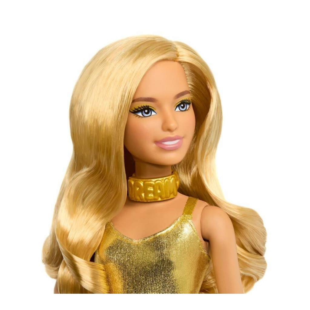 A close-up of a doll with long blonde wavy hair, blue eyes, and a gold collar, wearing a gold metallic top against a plain white background.
