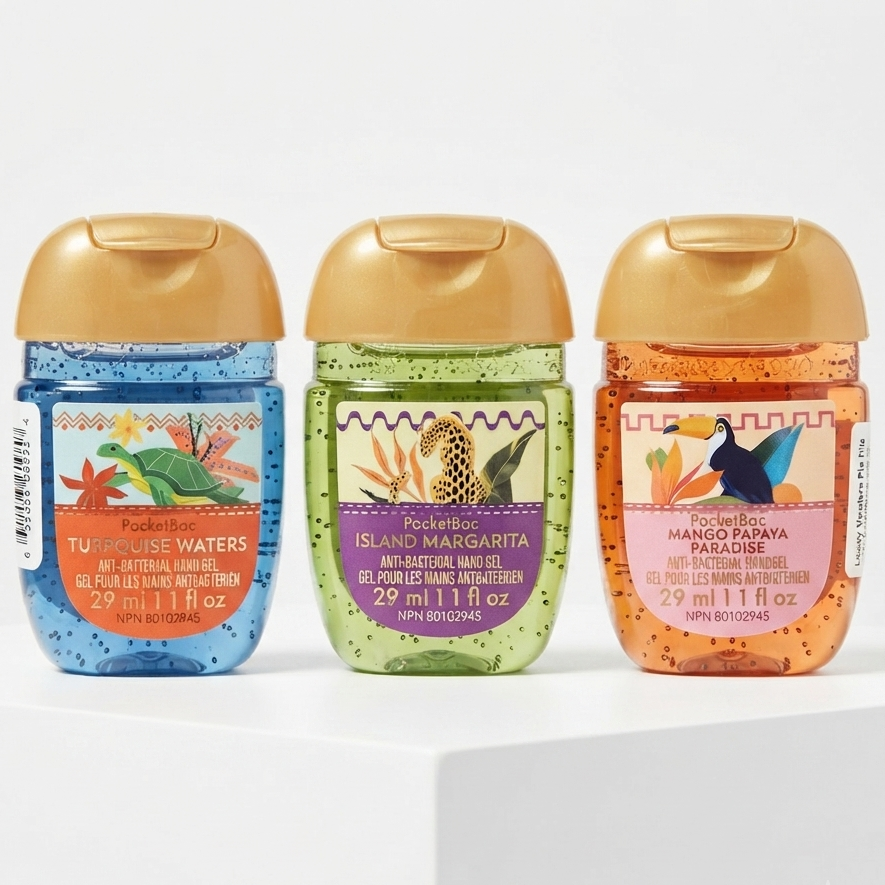 Three Pocketbook anti-slip hand sanitizer gel bottles lined up on a white pedestal against a white background. The bottles are in blue, green, and orange variants with gold caps and colorful labels featuring tropical animal illustrations.