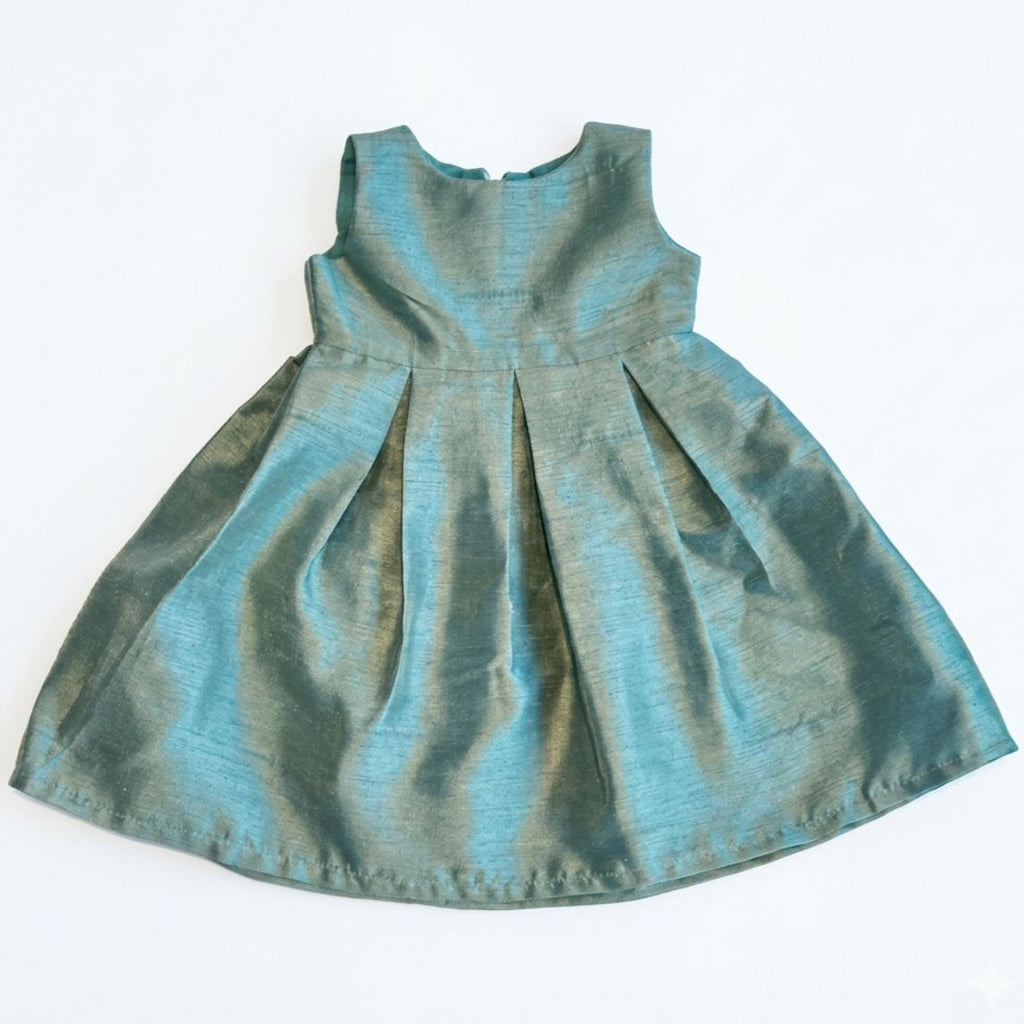 Green baby dress on a white background