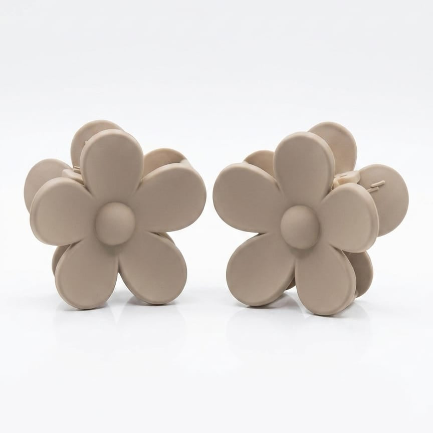 Pair of beige flower-shaped earrings on a white background