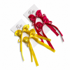 Two decorative hair bows on white cards, one in bright yellow and one in vivid pink, both embellished with small rhinestones and long ribbon tails. The card shows the brand name Belle.