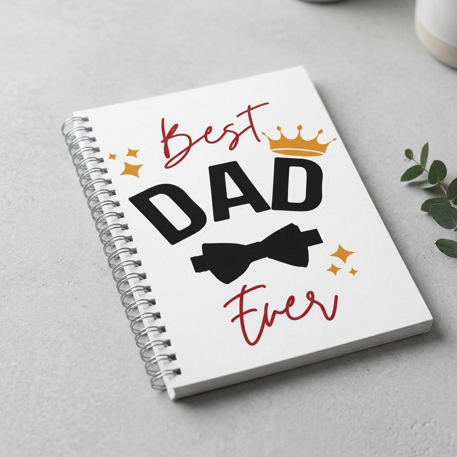 Notebook with 'Best Dad Ever' text on a light gray surface