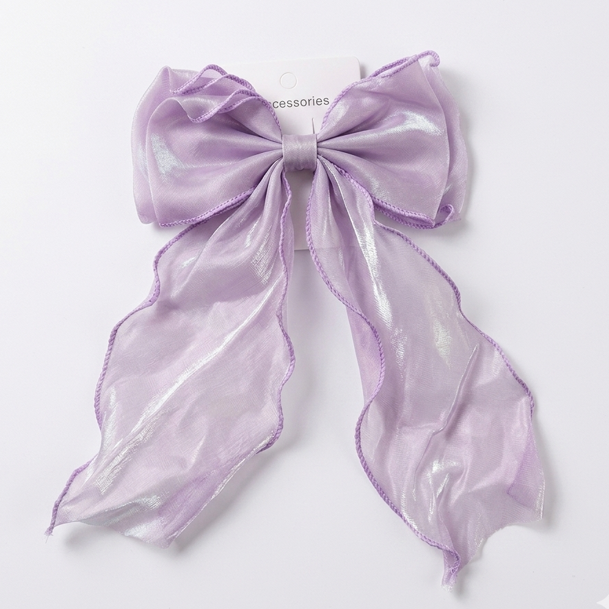 Lavender bow-shaped clip on a light gray background