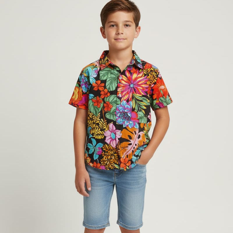 Child wearing a colorful floral shirt and denim shorts on a white background