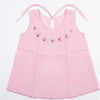 Pink dress with floral embroidery on a white background