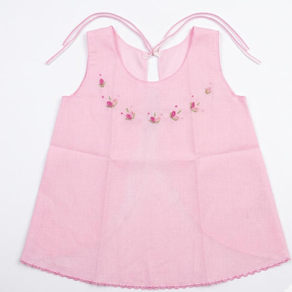 Pink dress with floral embroidery on a white background