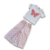 White t-shirt with pink butterfly design and matching pants on a white background