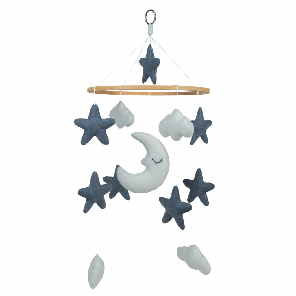 A handcrafted mobile with stars, clouds, and a moon-shaped felt hanging from a wooden ring. The mobile is primarily in shades of blue and gray.