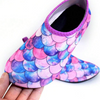 Children's swim shoes with a mermaid theme, featuring a scale pattern in shades of pink and purple.
