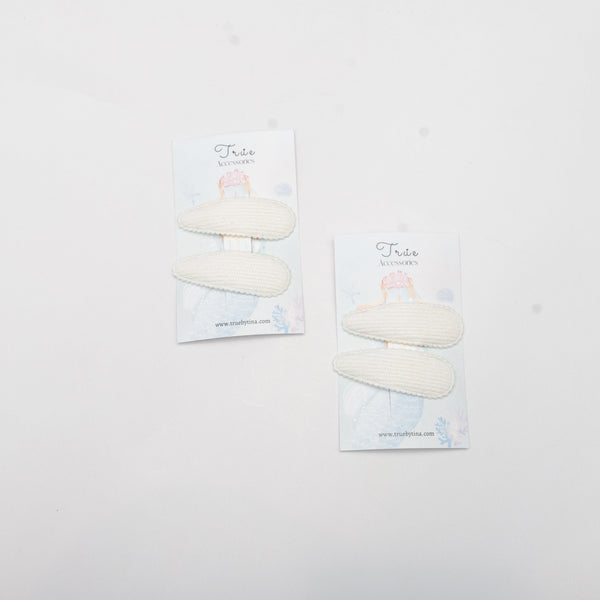 Two packages of white stones on a light gray background