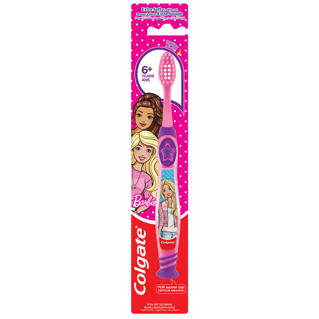 A Colgate kids' toothbrush in its original retail packaging. The toothbrush features a purple and pink handle with cartoon Barbie character graphics, and the packaging is bright pink and red with the Colgate logo.