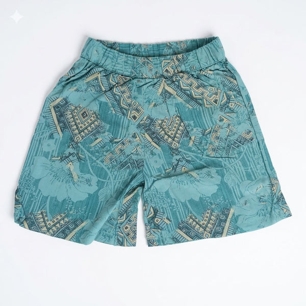 Teal patterned shorts on a white background