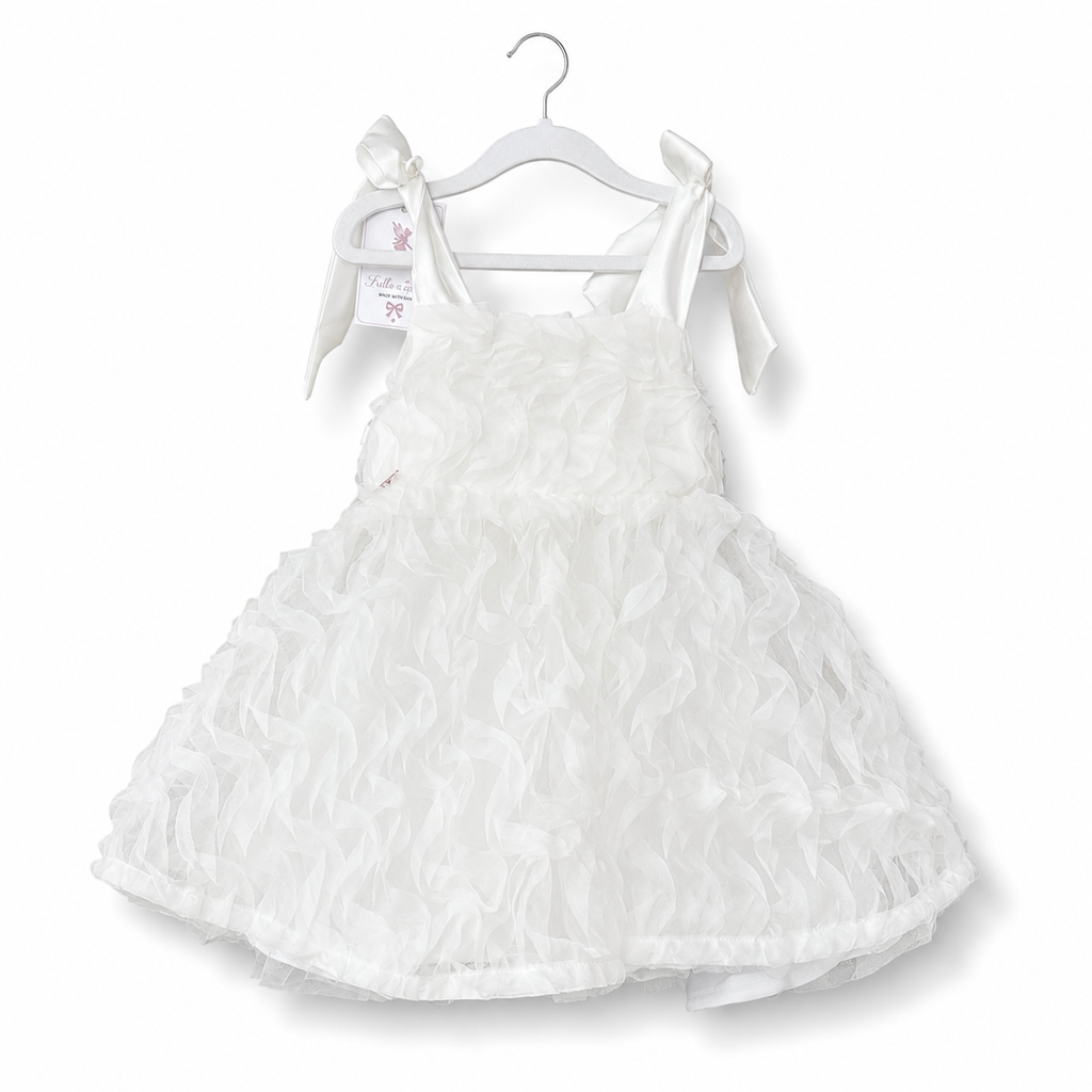 White dress with ruffled details on a white background