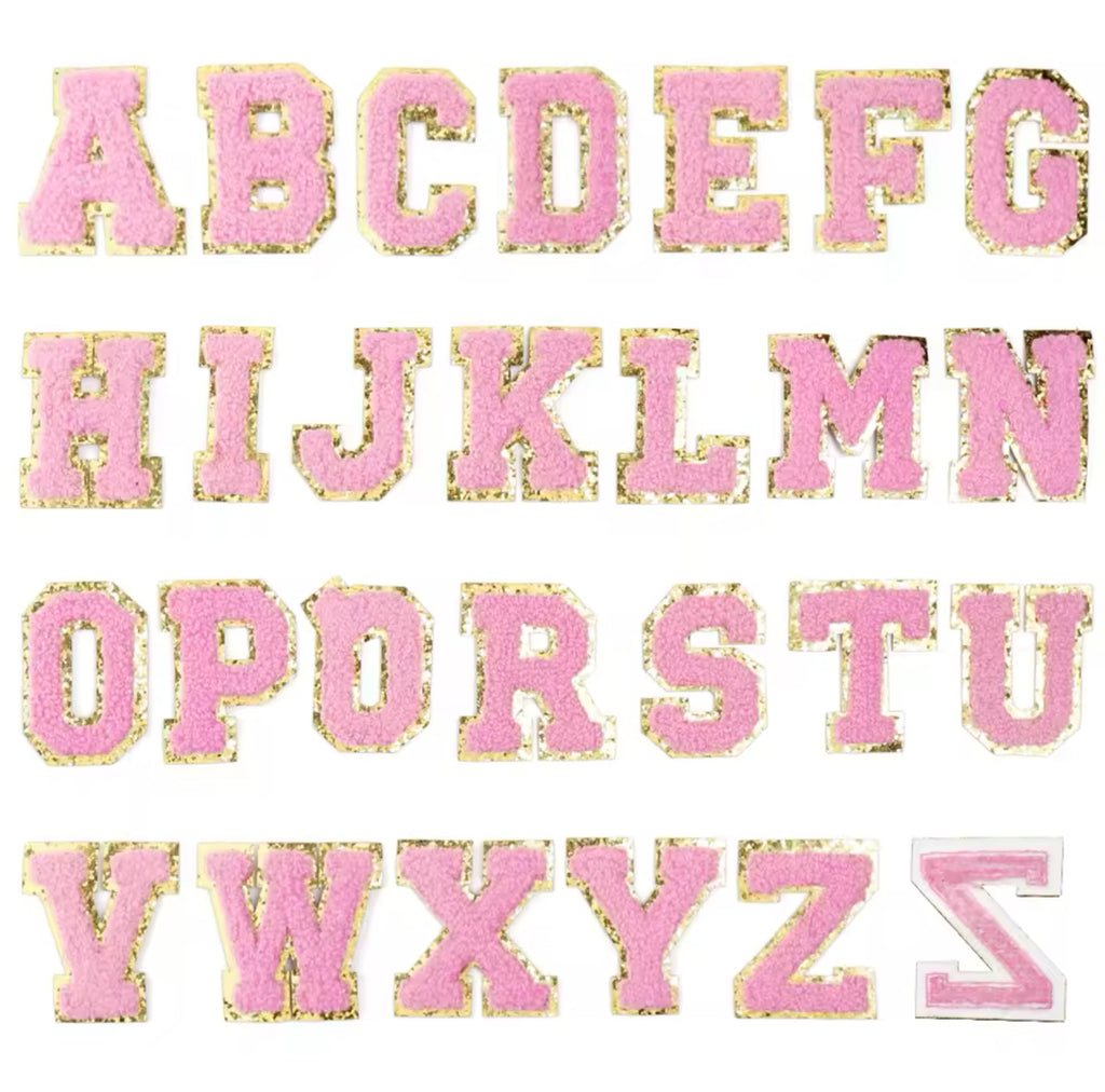 A set of light pink embroidery fabric letter patches, each letter is presented in a different font style, and they are all embroidered in a pink color.