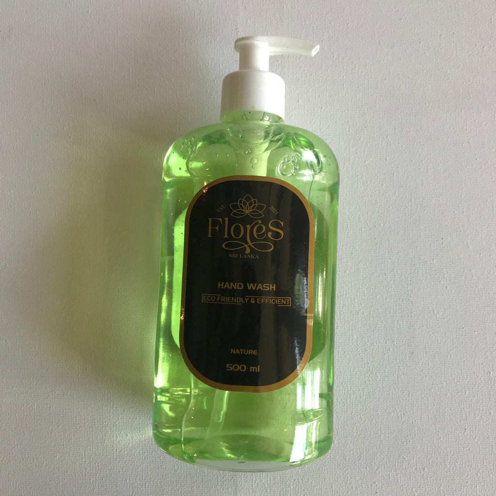 A 500ml clear pump bottle of Flores Eco handwash with a greenish tint and a label that includes the brand name and product description.