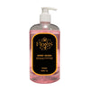 A clear plastic bottle with a pump dispenser containing pink handwash labeled 'Flores Hand Wash' with text indicating rose scent and 500ml volume.
