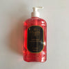 A red plastic bottle with a pump dispenser labeled 'Floras' containing pink handwash with a cap and branding on the label.