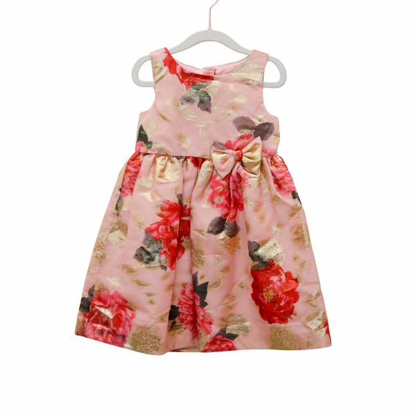Floral dress with a large bow on a white hanger